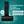 Load image into Gallery viewer, Black neck pillow with Canadian Spa Co. branding on a teal background, highlighting features and measurements.
