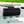 Load image into Gallery viewer, Black headrest on a hot tub with text about comfort and a brand logo.
