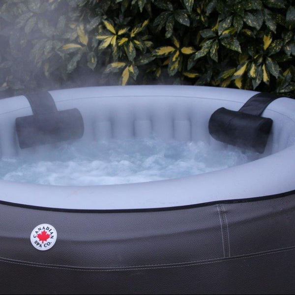 Inflatable hot tub with water features in a garden setting
